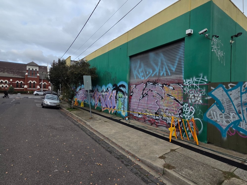 Commercial building with graffiti before repaint